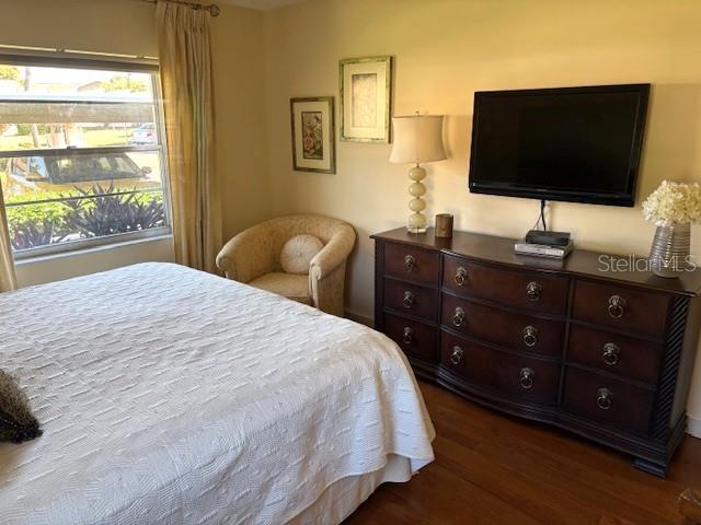 404 Feltham Trail, Unit B Sun City Center, FL 33573 - Photo 39 of 59 a bedroom with a bed and a flat screen tv