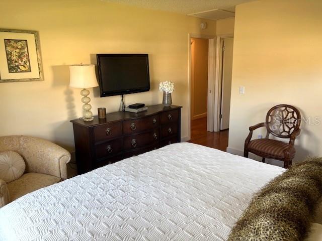 404 Feltham Trail, Unit B Sun City Center, FL 33573 - Photo 40 of 59 a bedroom with a bed and a flat screen tv