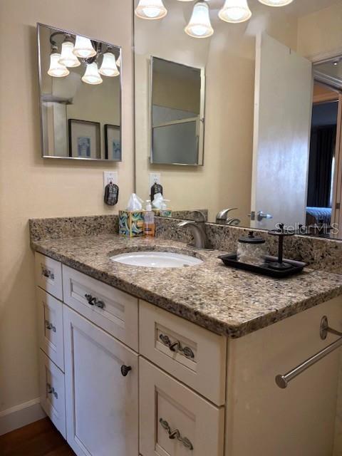 404 Feltham Trail, Unit B Sun City Center, FL 33573 - Photo 44 of 59 a bathroom with a granite countertop sink and a mirror