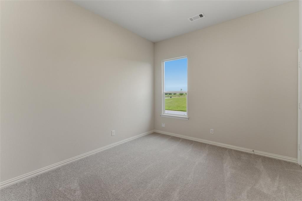 119 Hillview Trail Decatur, TX 76234 - Photo 8 of 30 Room featuring neutral wall paint, gray carpeting, a single window, white baseboards, and a ceiling vent
