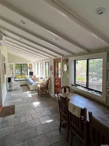 a living room with furniture and large windows