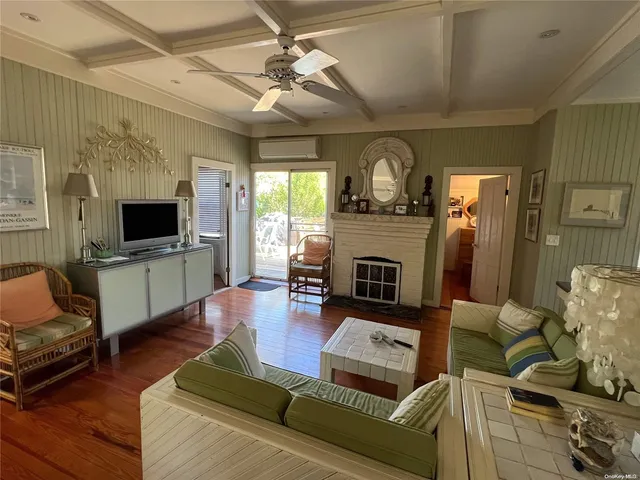 a living room with furniture fireplace and flat screen tv