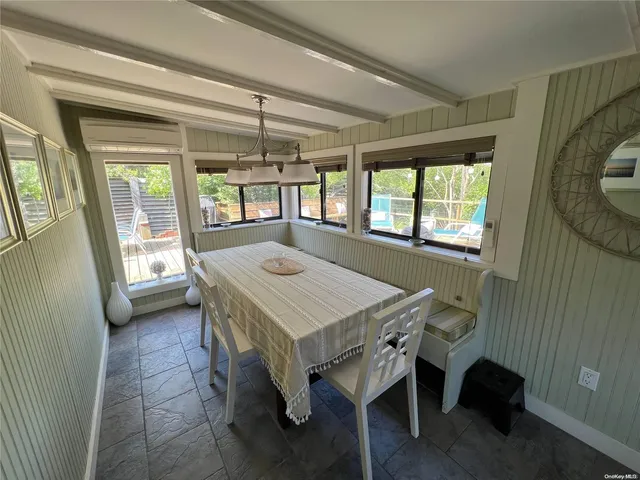 a view of a dining room with furniture and windows