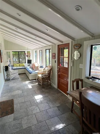 a living room with furniture a window and a flat screen tv