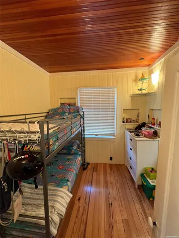 a room with wooden floor and furniture