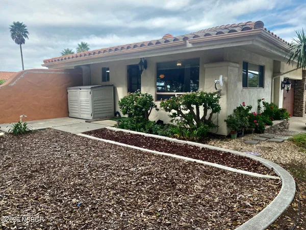 a view of a house with potted plants