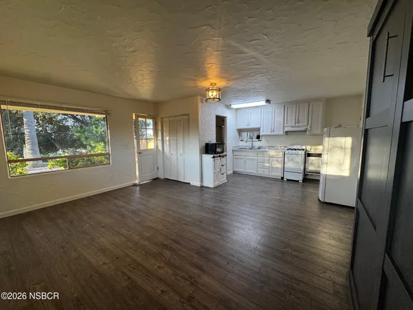 a view of kitchen with cabinets and wooden floor