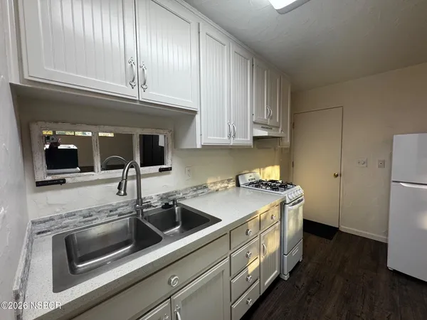 a kitchen with a sink and cabinets