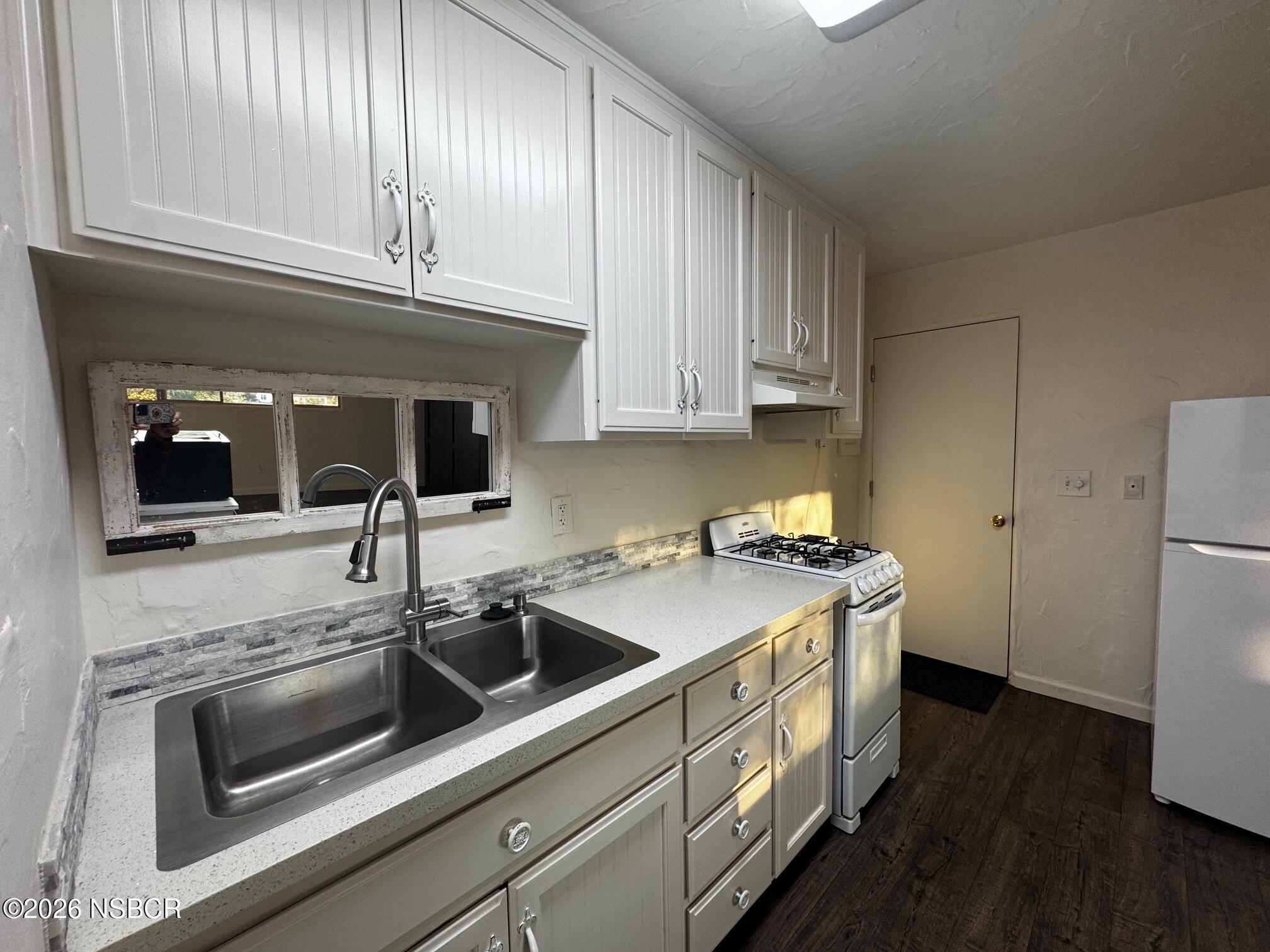 460 Rim Rock Road Nipomo, CA 93444 - Photo 5 of 7 a kitchen with a sink and cabinets