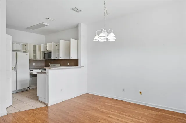 a view of kitchen with refrigerator and microwave