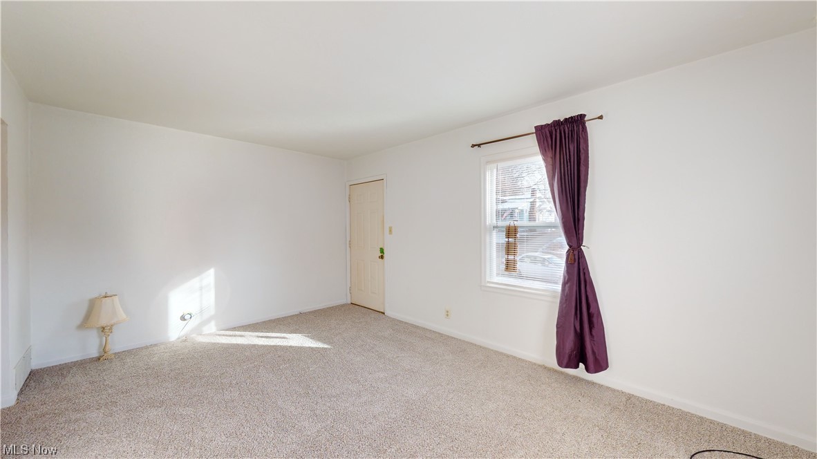 804 Kickapoo Avenue Akron, OH 44305 - Photo 3 of 24 Living room with brand new 2023: paint, carpet, blinds, and window treatments. There are hardwood floors under the carpet.