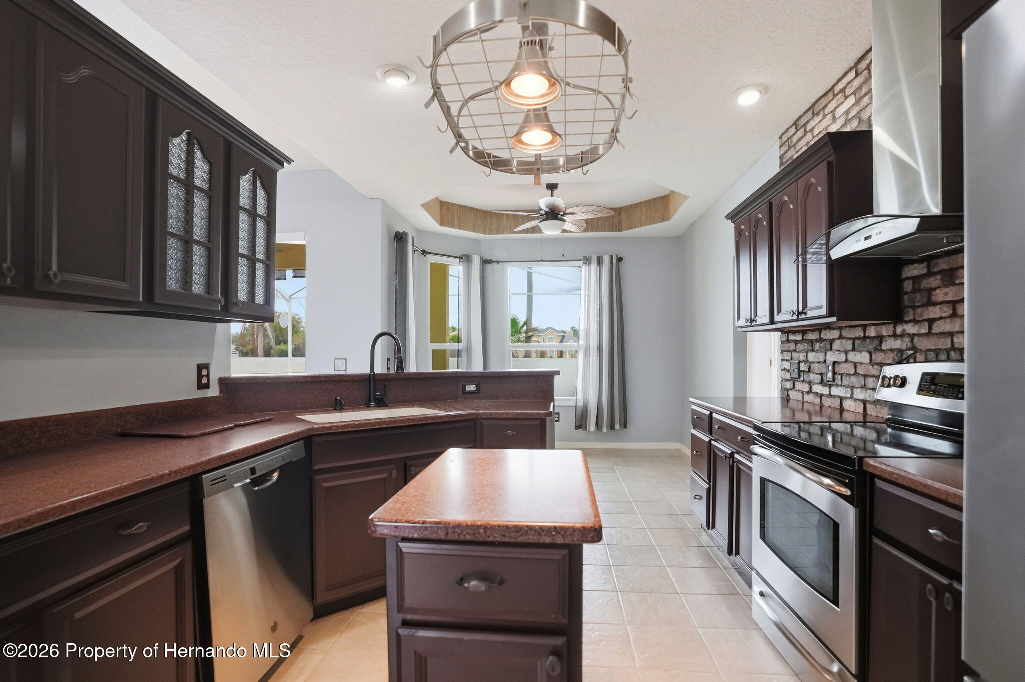 18131 Rivard Boulevard Brooksville, FL 34604 - Photo 16 of 66 a kitchen with a sink stainless steel appliances and cabinets