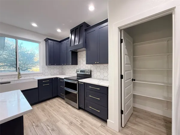a kitchen with stainless steel appliances a refrigerator and a stove