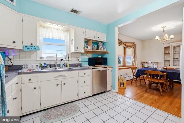 a kitchen that has a lot of cabinets a sink and a stove in it