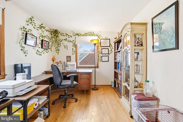 a view of a workspace with furniture and a window
