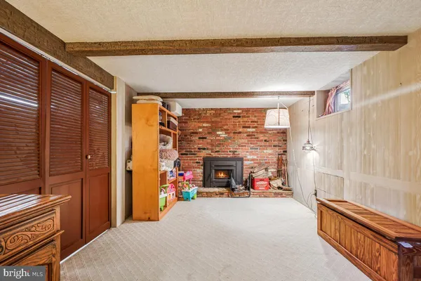 a bedroom with furniture and a fireplace