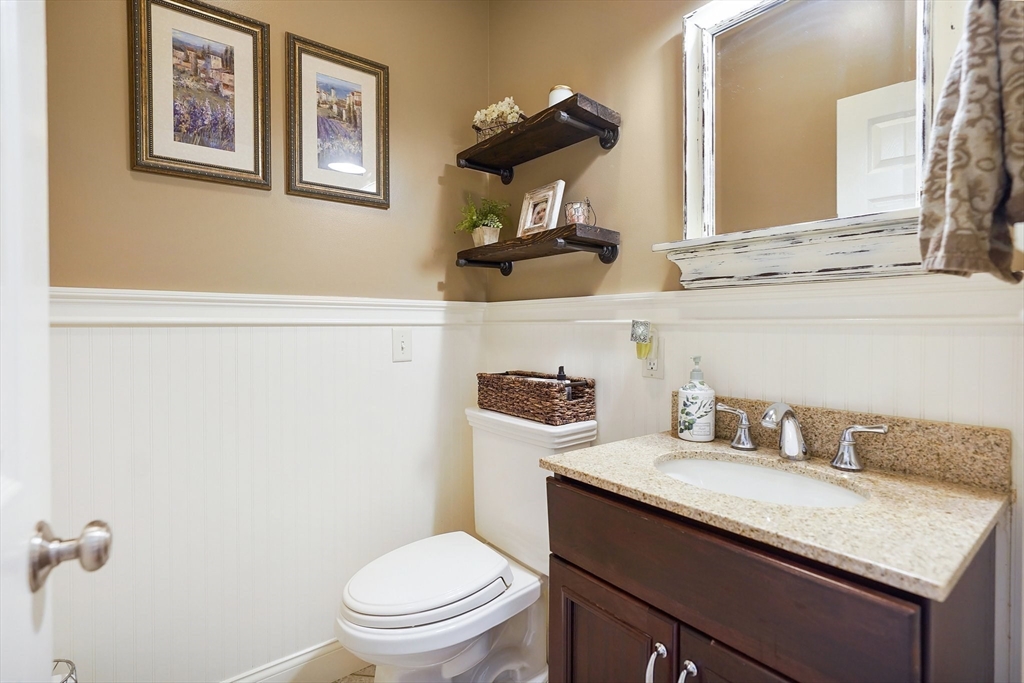 24 Two Ponds Road Belchertown, MA 01007 - Photo 23 of 41 a bathroom with a granite countertop toilet sink and mirror