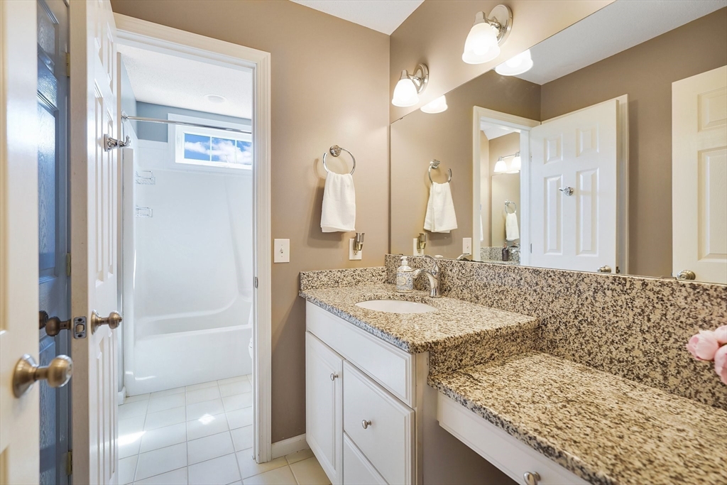 24 Two Ponds Road Belchertown, MA 01007 - Photo 26 of 41 a bathroom with a granite countertop sink and a mirror