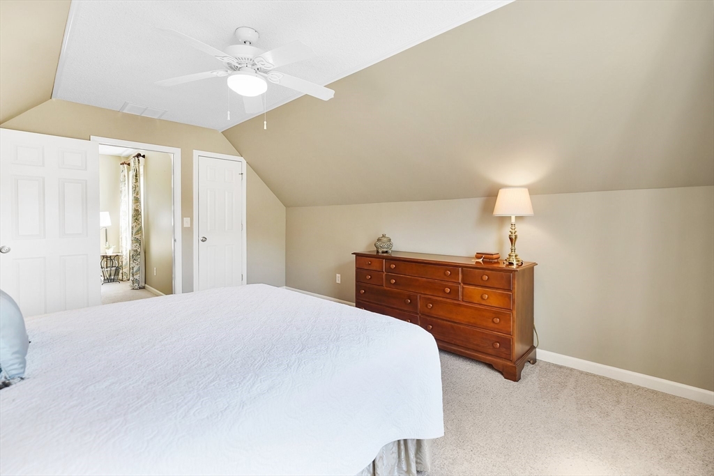 24 Two Ponds Road Belchertown, MA 01007 - Photo 28 of 41 a bedroom with a bed and a chandelier