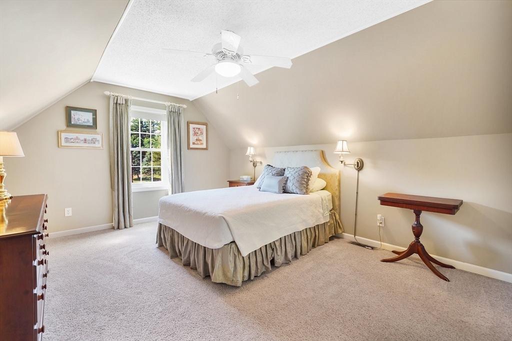 24 Two Ponds Road Belchertown, MA 01007 - Photo 29 of 41 a spacious bedroom with a bed and a chandelier