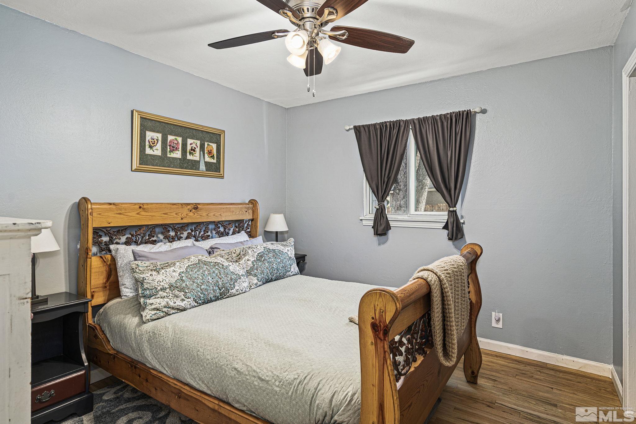 20 Kaye Way Reno, NV 89509 - Photo 12 of 17 a bedroom with a bed and wooden floor