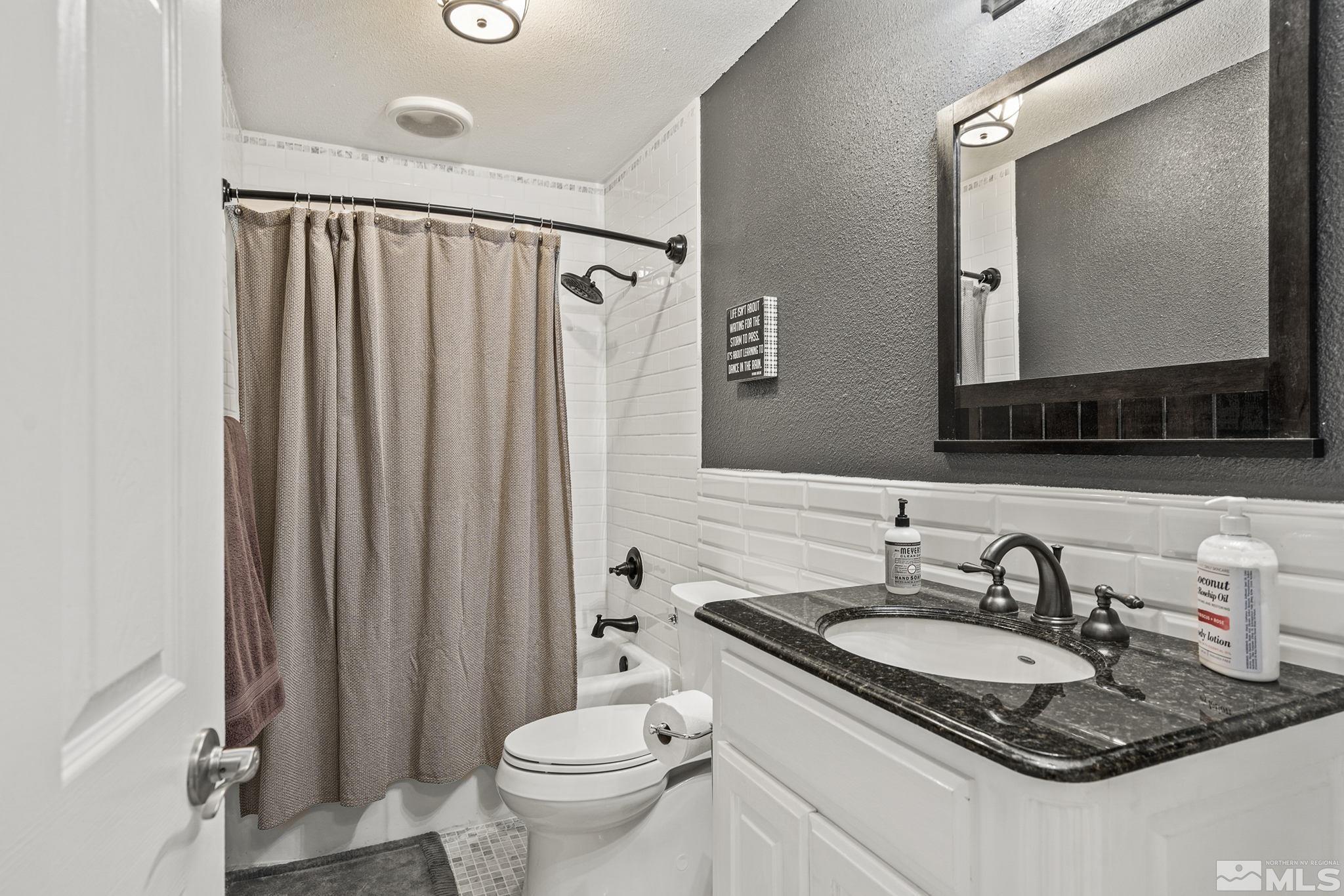 20 Kaye Way Reno, NV 89509 - Photo 13 of 17 a bathroom with a granite countertop sink toilet and mirror