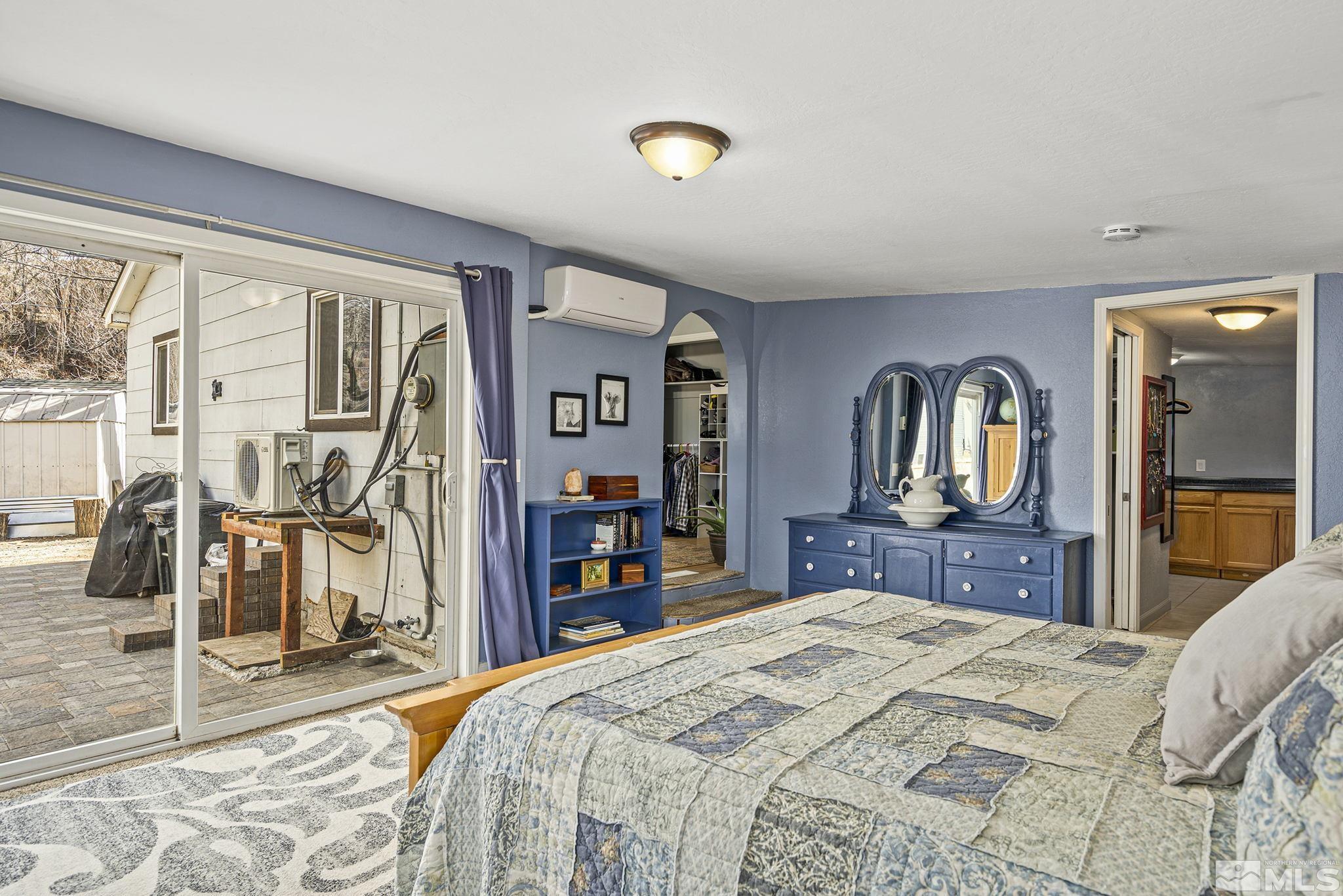 20 Kaye Way Reno, NV 89509 - Photo 8 of 17 a bedroom with a bed and a dresser with mirror