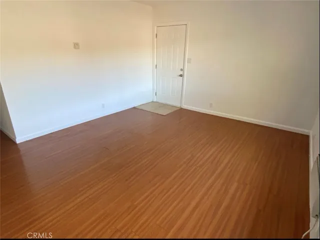 an empty room with wooden floor