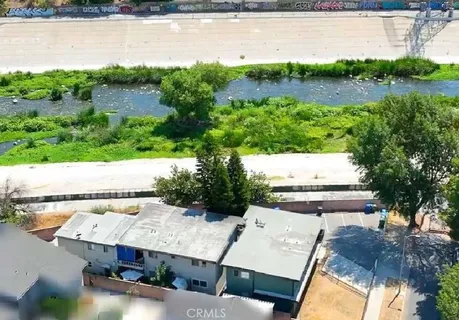 an aerial view of a house with a yard and lake view