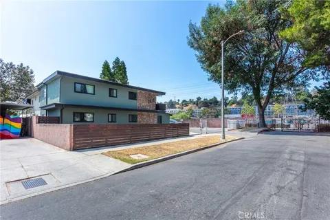 a view of a house with pool and a yard