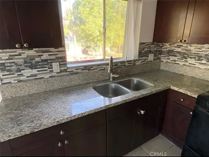 a kitchen with a sink and a window