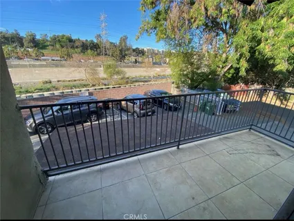 a view of a balcony with wooden floor and city view