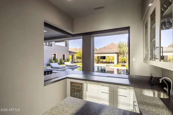 a kitchen with stainless steel appliances granite countertop a sink and cabinets