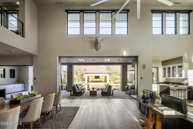 a spacious bedroom with a bed and a flat screen tv
