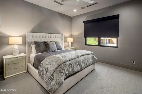 a living room with furniture and a floor to ceiling window