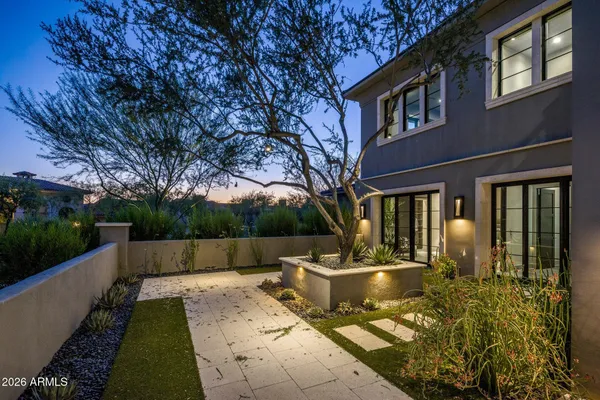 a front view of a house with outdoor seating