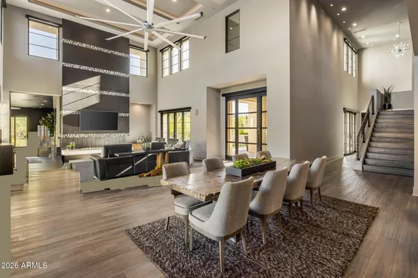 a living room with furniture kitchen view and a large window
