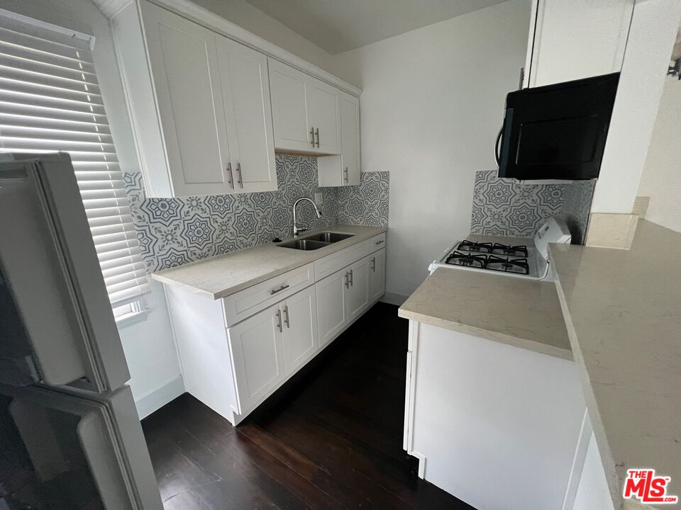 1217 Cedar Avenue Long Beach, CA 90813 - Photo 11 of 15 a kitchen with a sink stove and microwave