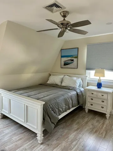 a bedroom with a bed and a ceiling fan