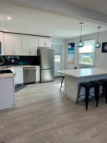 a kitchen with refrigerator and cabinets