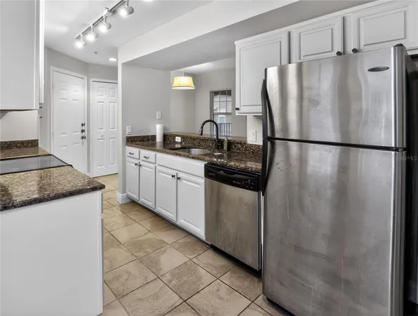 a view of a kitchen with an empty space and a window