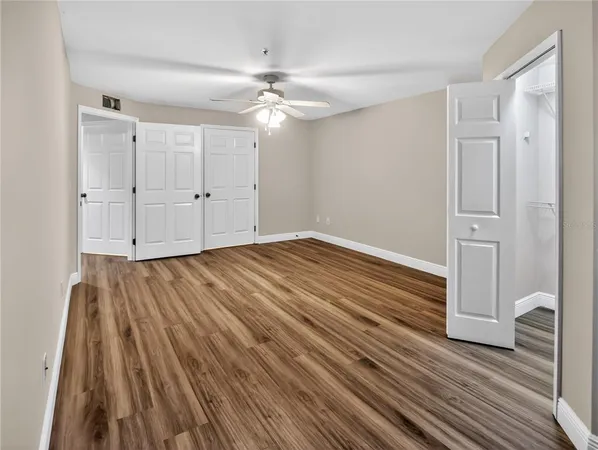 a view of an empty room with wooden floor
