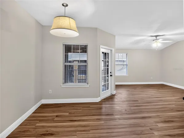 a view of a room with wooden floor and window
