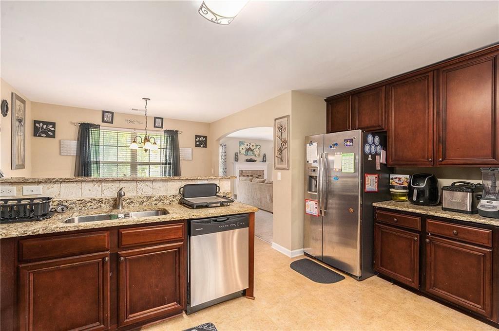 Undisclosed Address Hampton, GA 30228 - Photo 19 of 45 a kitchen with stainless steel appliances granite countertop a refrigerator stove and sink