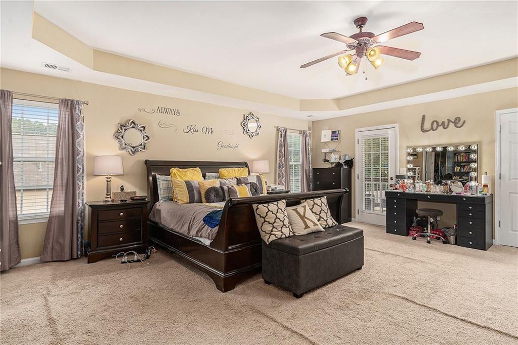 Undisclosed Address Hampton, GA 30228 - Photo 23 of 45 a spacious bedroom with a bed a couch and dresser