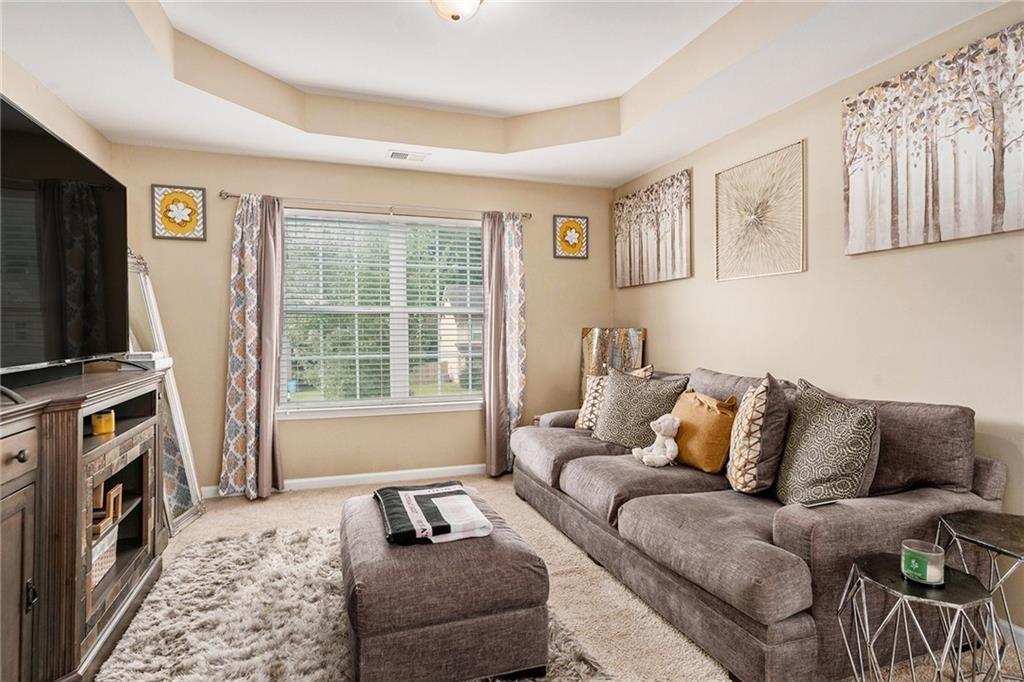 Undisclosed Address Hampton, GA 30228 - Photo 35 of 45 a living room with furniture a flat screen tv and a window