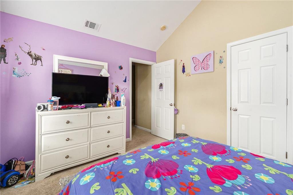 Undisclosed Address Hampton, GA 30228 - Photo 37 of 45 a bedroom with a bed and a flat screen tv