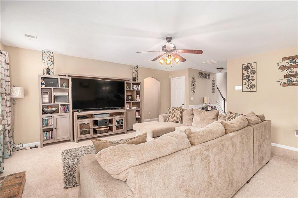 Undisclosed Address Hampton, GA 30228 - Photo 5 of 45 a living room with furniture and a flat screen tv