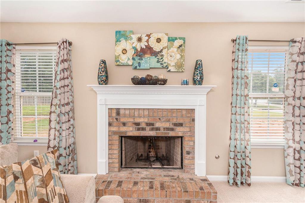 Undisclosed Address Hampton, GA 30228 - Photo 7 of 45 a living room with a fireplace and a window