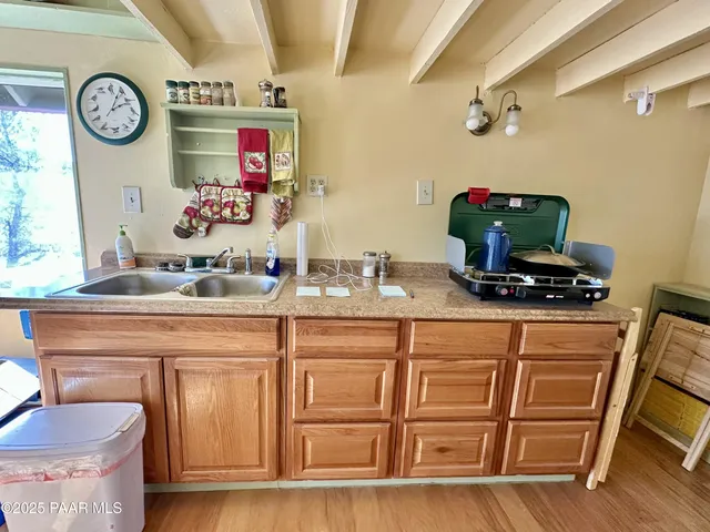 a utility room with granite countertop a sink and a stove